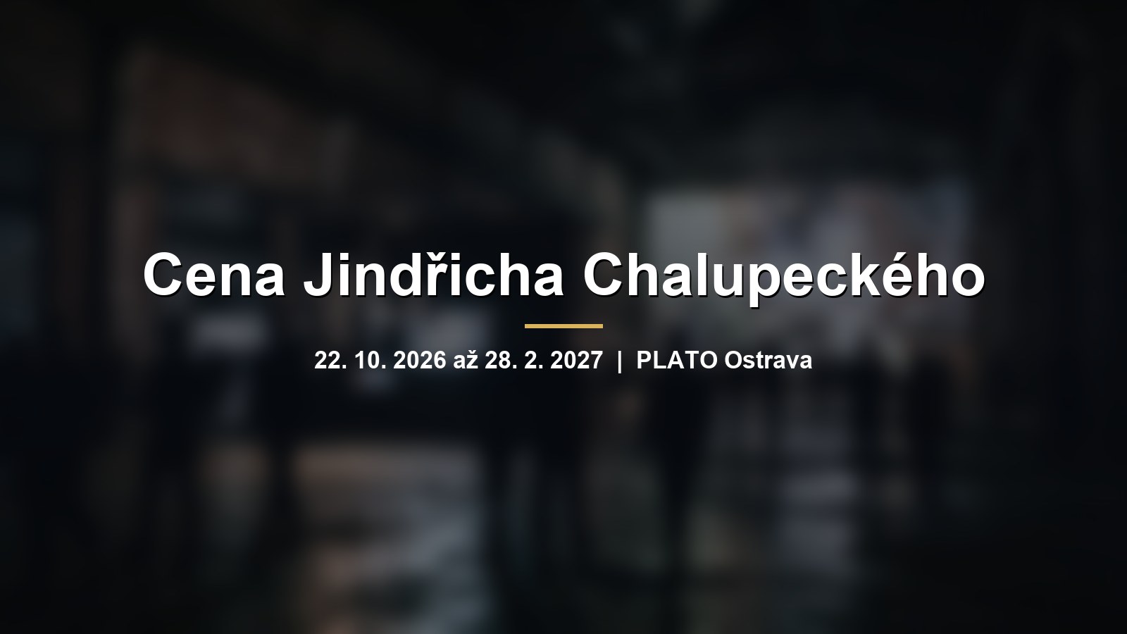 Rozmazaná výstava současného umění v cihlové industriální hale s nápisem Cena Jindřicha Chalupeckého