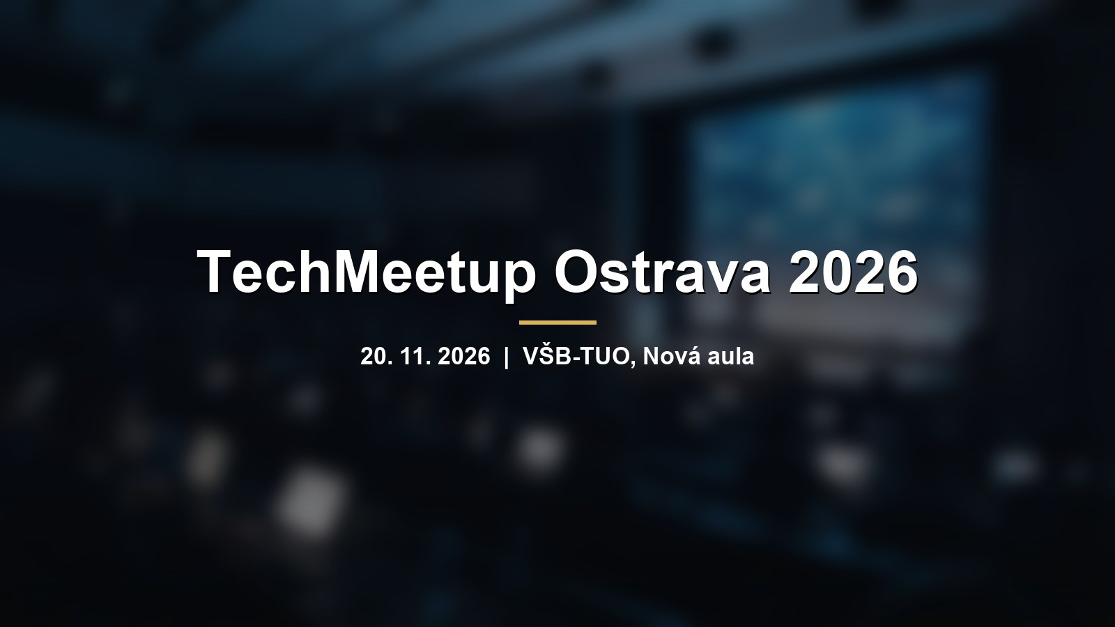 Rozmazaný konferenční sál s modrou obrazovkou a nápisem TechMeetup Ostrava 2026